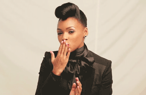 Gif of Janelle Monae blowing a kiss at the camera