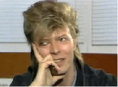 mullet,celebrities,smile,photoset,interview,adorable,hair,david bowie,smiling,david bowie interview,expression,bowie,glass spider,rock star,big hair,sighing,fluffy hair,touching face