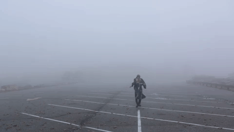 dance,happy,creepy,scary,odd,fog,mysterious,parking lot,trenchcoat