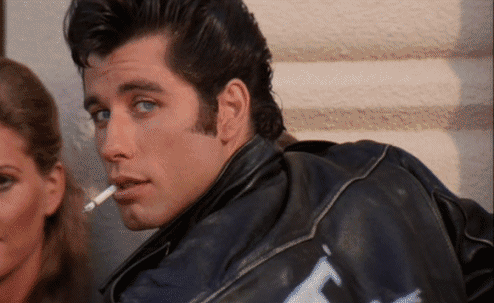 john travolta,smirk,grease,smoke,hair,eyes,70s