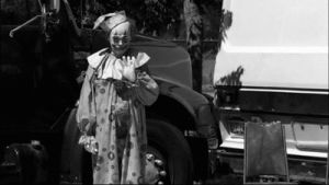 scary,goodbye,fear,circus,clown,psycho,psychopath,black and white,horror,smile,car,man,crazy,creepy,boy,hand,waving,horror movie,nightmare,make up,fake smile,panel dress