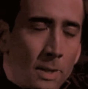 nicolas cage trying not to laugh gif