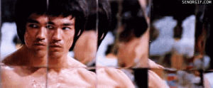 bruce lee,boxing,fighting,enter the dragon,movies,celebrities,watching,looking,acting,mirrors