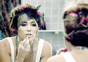 lipgloss,getting ready,hair curlers,miley cyrus,lipstick,make up,geting ready,putting on make up,putting on lipstick,test your might,trippy picture