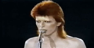 talk,celebrities,singer,white,david bowie,stage,shirtless,live show,ziggy stardust,loveual frustration,colored hair