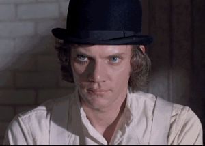 a clockwork orange,malcolm mcdowell,art,movies,film,fashion,eyes,style,beautiful,indie,makeup,orange,british,actors,stanley kubrick,blue eyes,menswear,glam,classy,hats,eyelashes,british films,english men